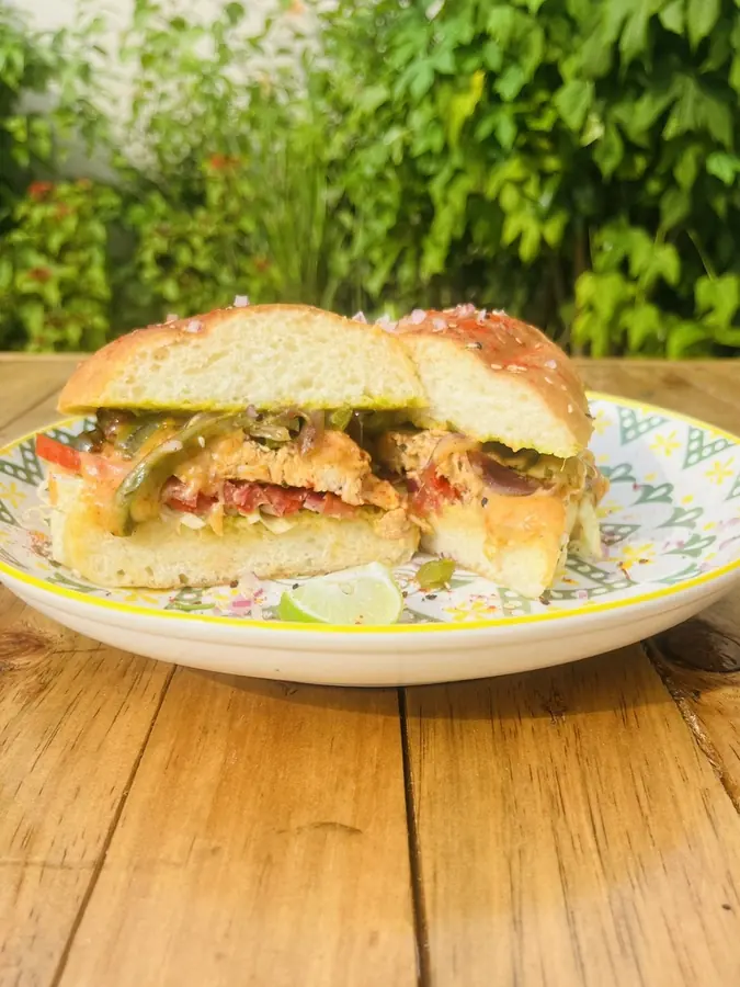 A chicken torta cut in half